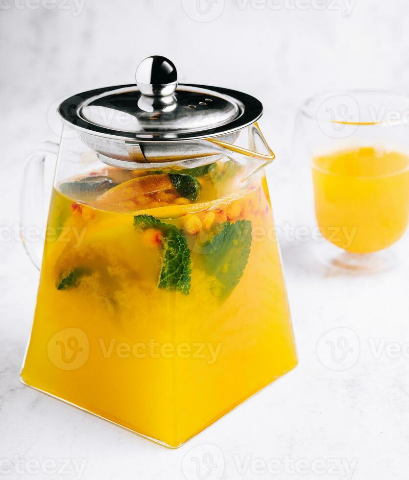 tea with mint and orange. aromatic hot drink in glass jar. photo