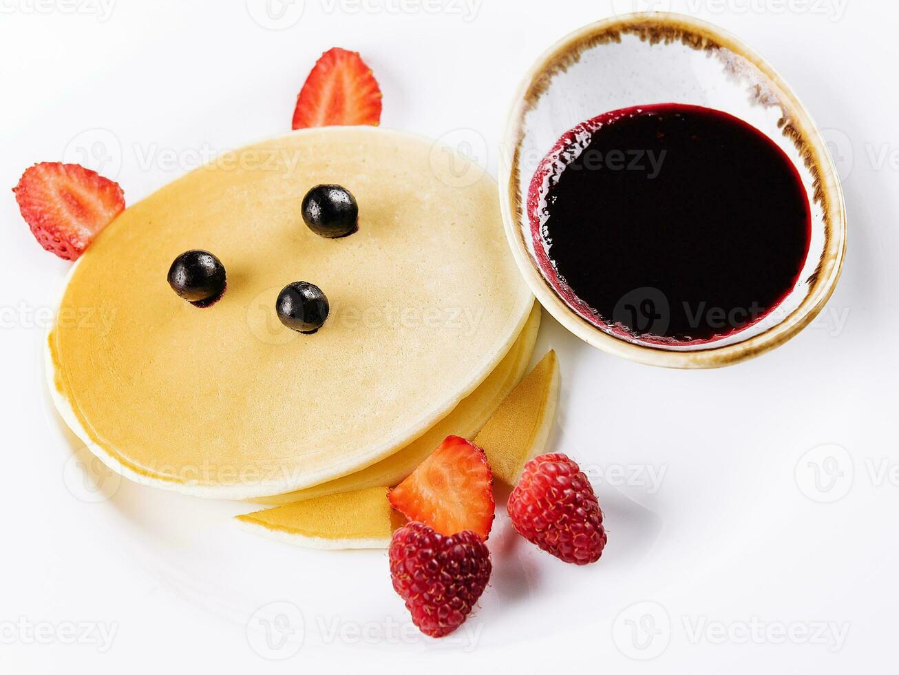 one pancake with strawberries and raspberries photo