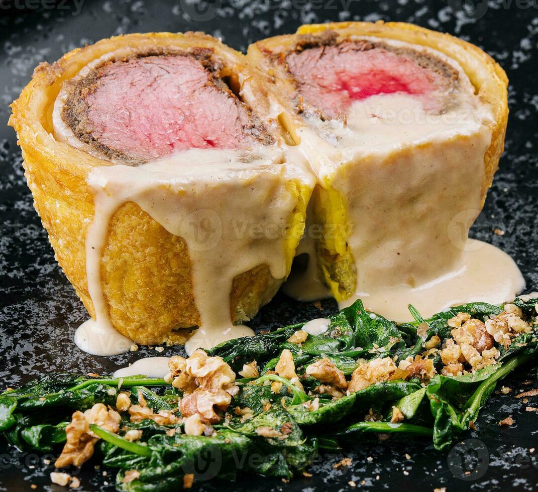Pork tenderloin en croute on black plate 31753255 Stock Photo at Vecteezy