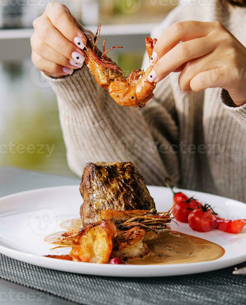 Filet mignon with shrimps and glass of wine photo