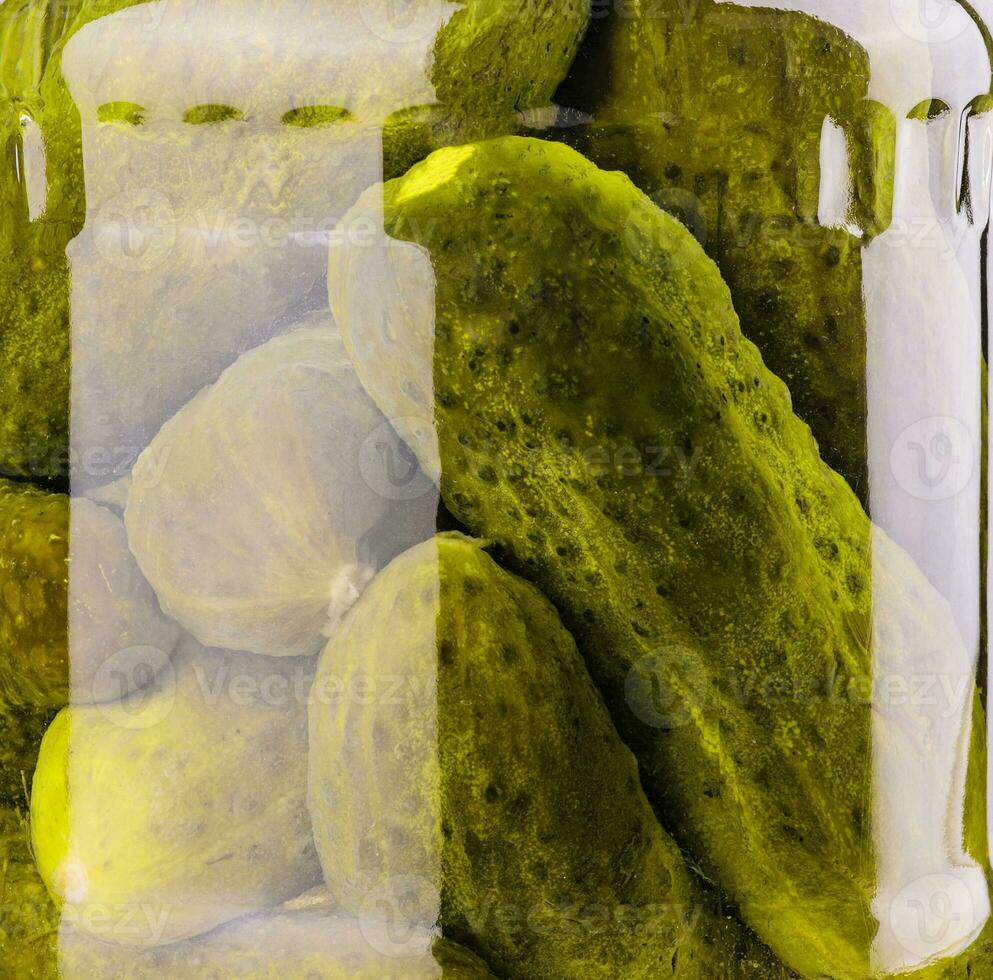 A glass jar of tasties canned cucumbers closeup photo