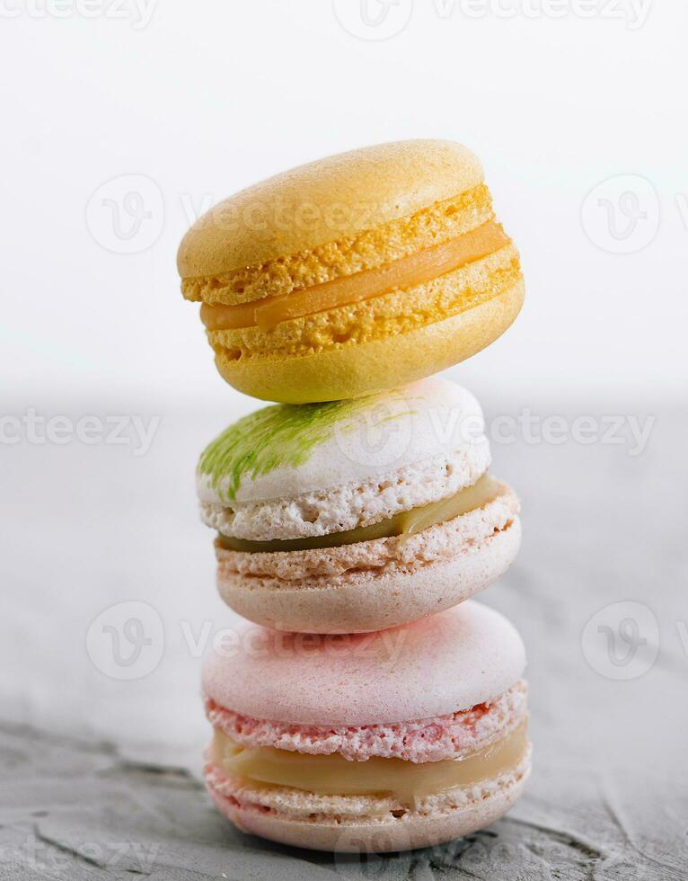 Stack of french colorful macaroons on stone photo