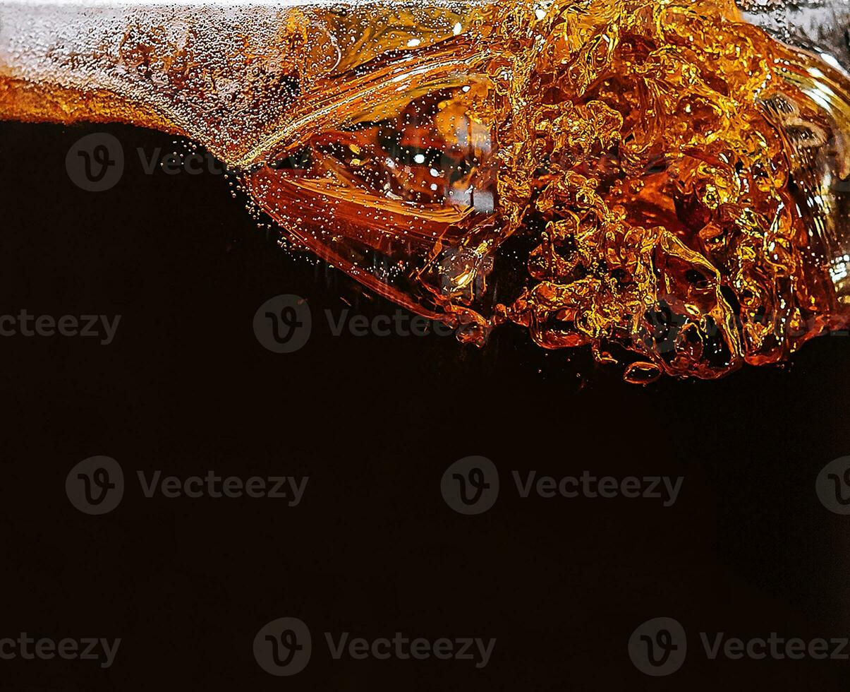 splashes in glass of dark Belgian beer photo