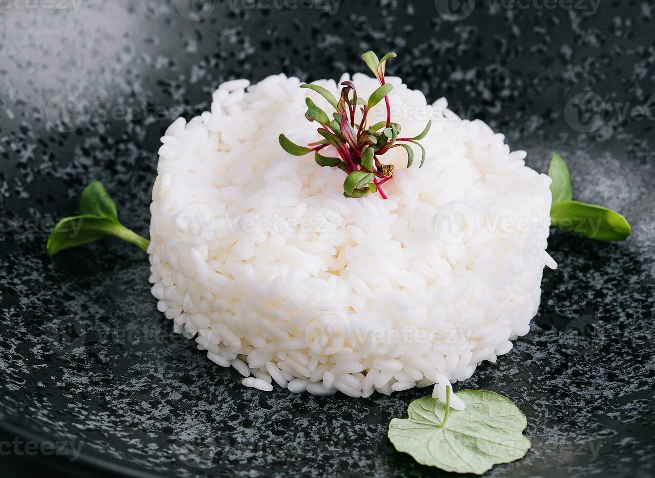 Portion of classic italian risotto on black plate photo