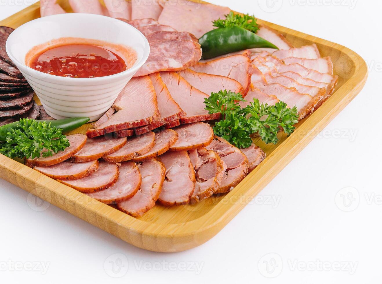 Assorted deli cold meats on wooden tray photo