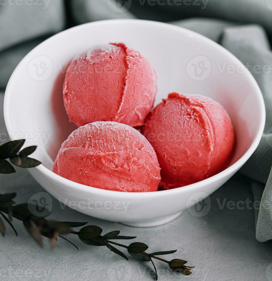 strawberry ice cream balls in a white bowl photo