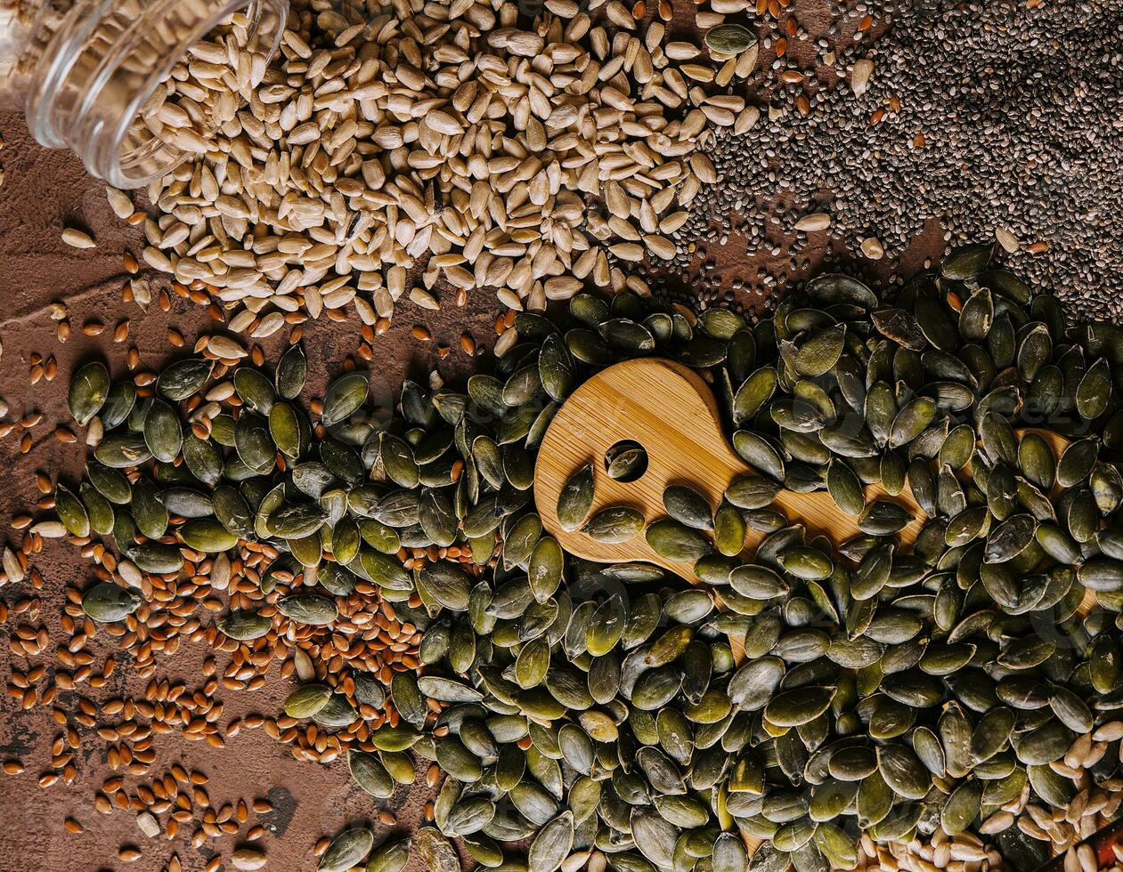 Different types of grains and seeds on shabby wooden photo