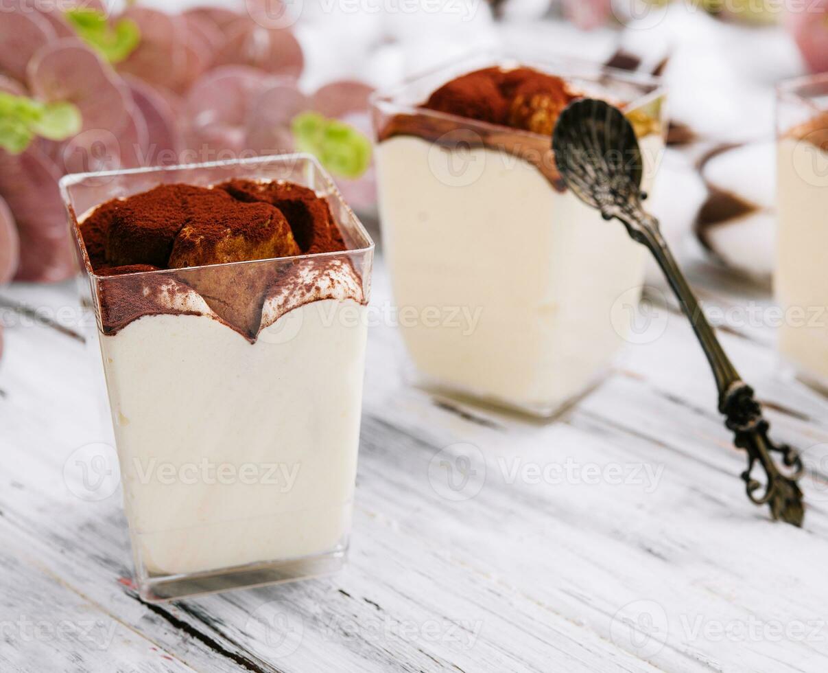 Traditional italian dessert tiramisu in a glass photo