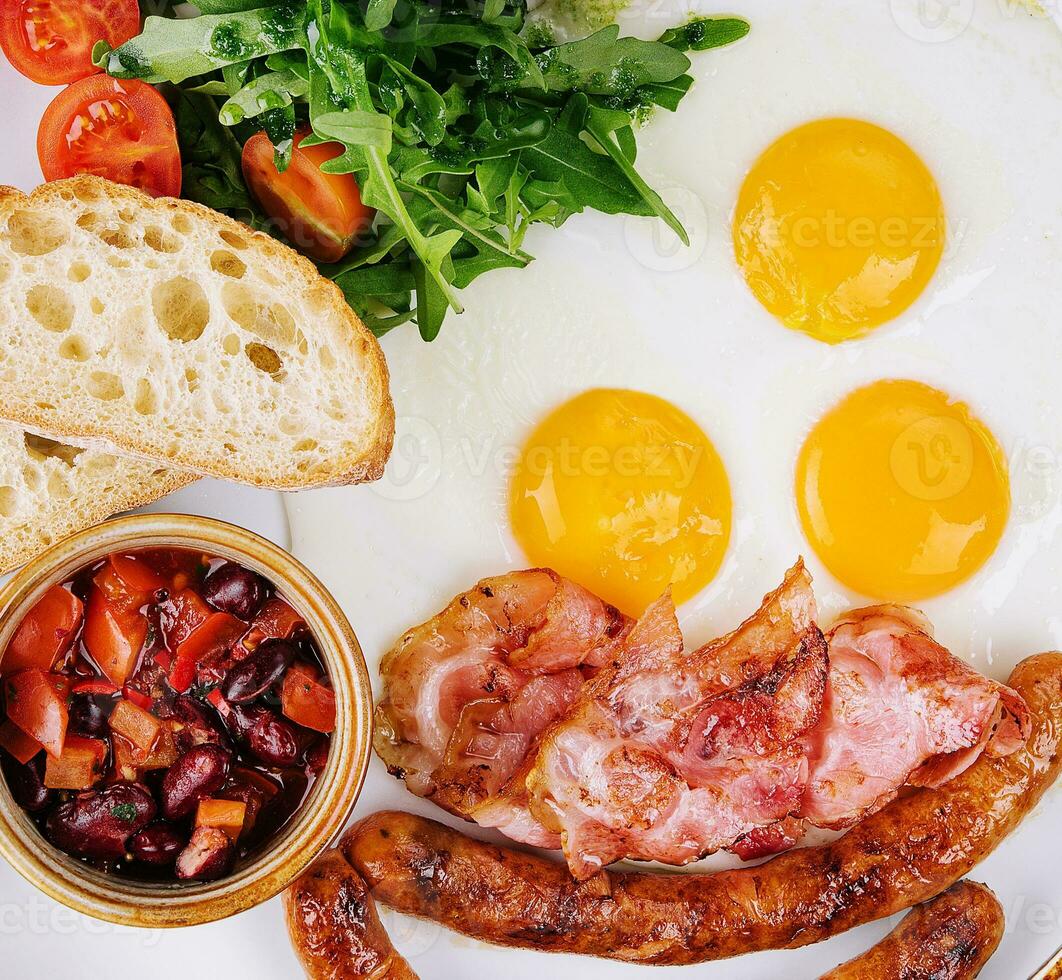 Fried eggs and bacon for breakfast on a plate photo