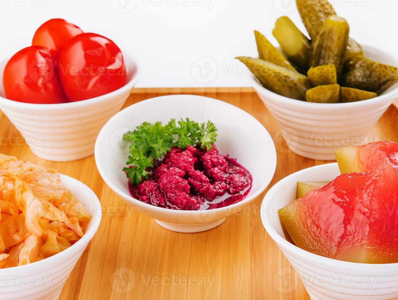 different pickles in Moldovan style on wood board photo
