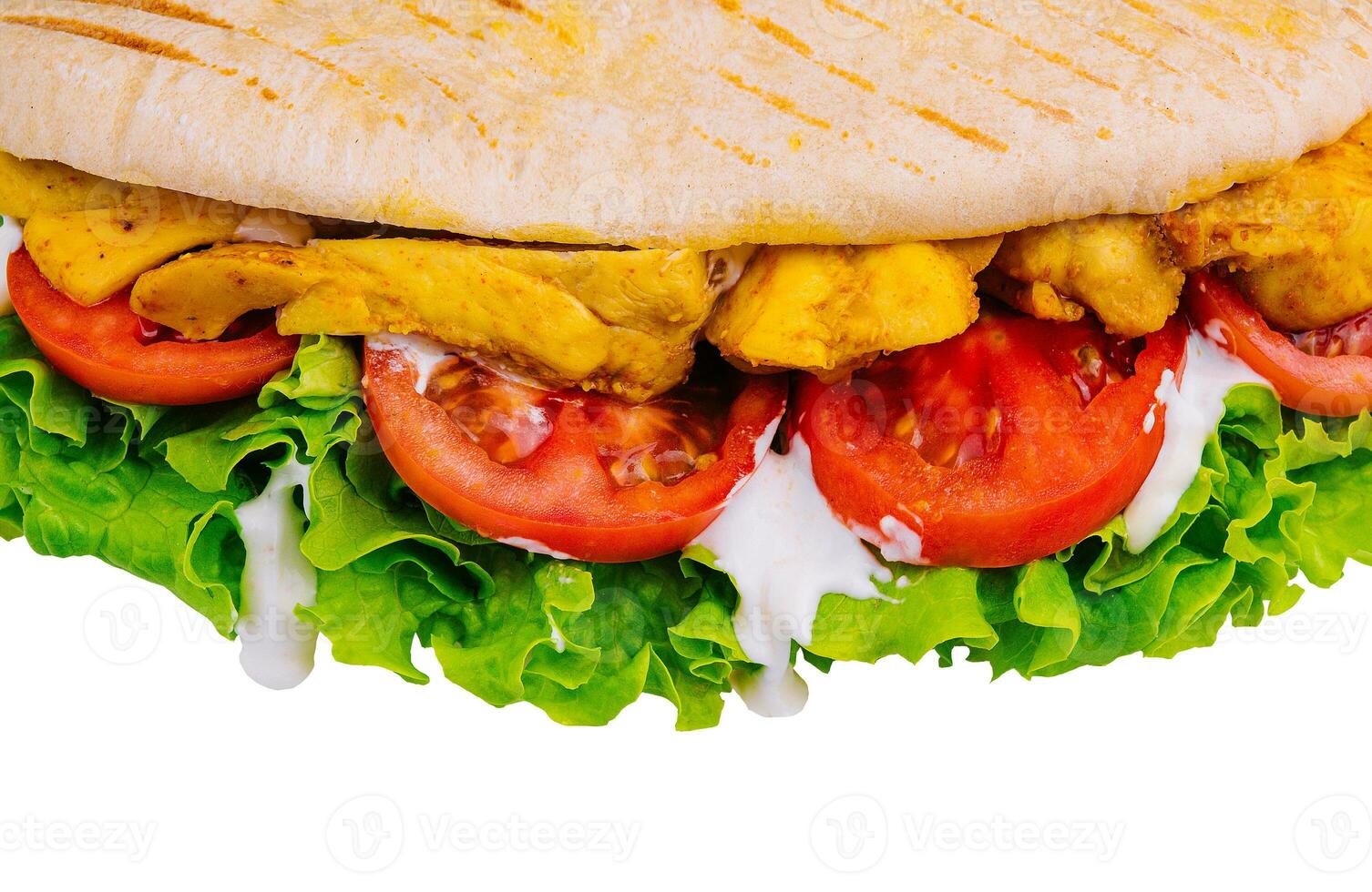 Doner kebab - fried chicken meat with vegetables in pita bread photo