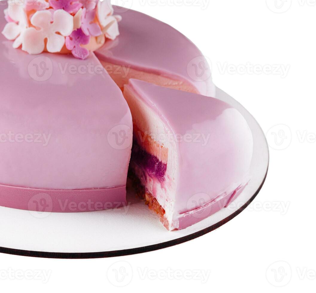 Pink mousse cake with mirror glaze decorated with flowers photo