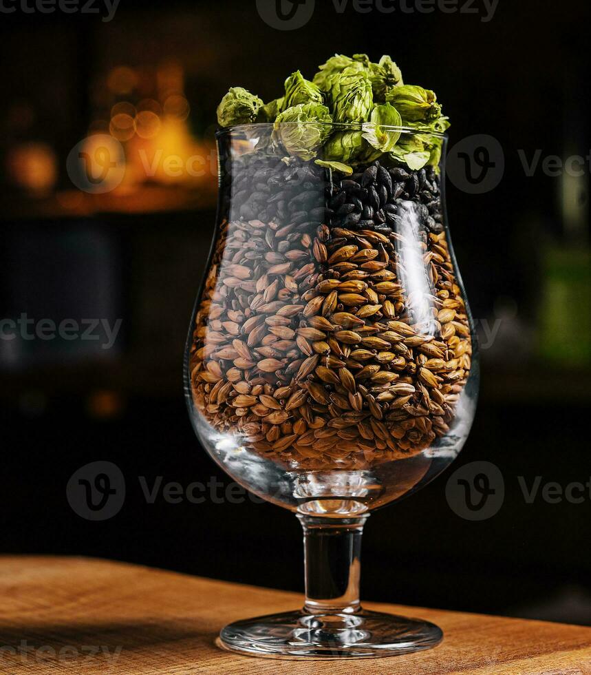 Hops and wheat in a glass for beer photo