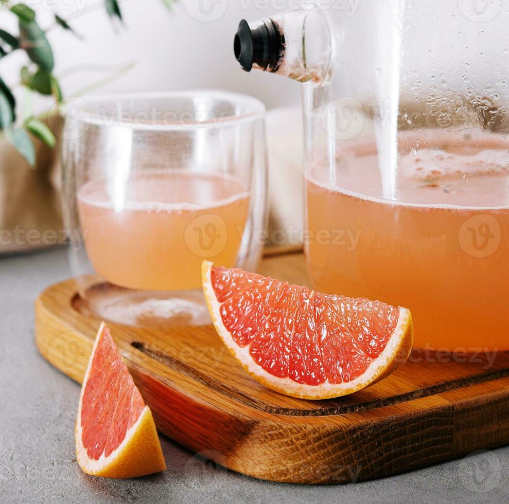 Summer refreshing grapefruit drink, jug and glass photo
