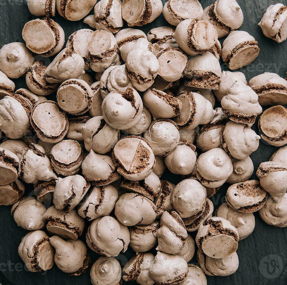 Chocolate meringues scattered on the table photo