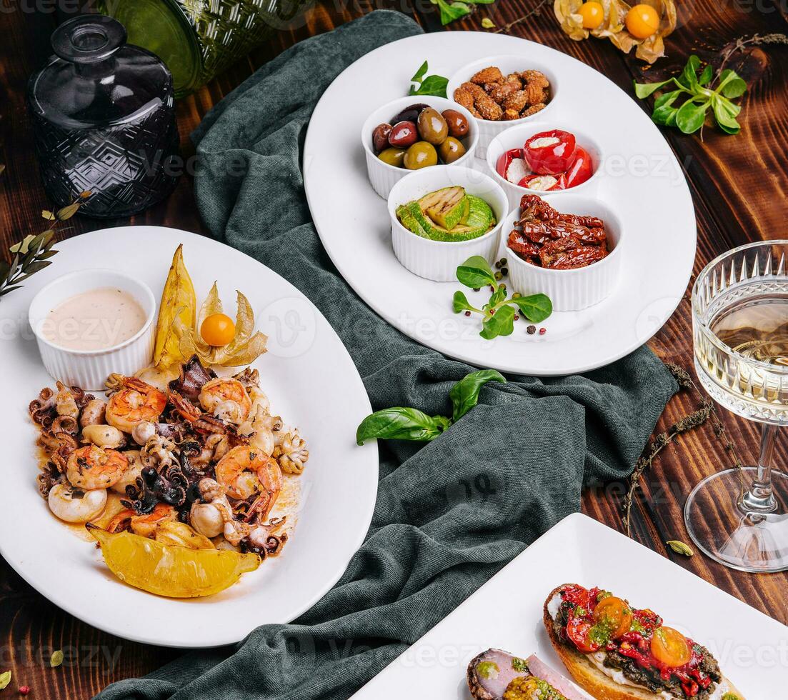 Bruschetta with various fillings with a plate of seafood photo