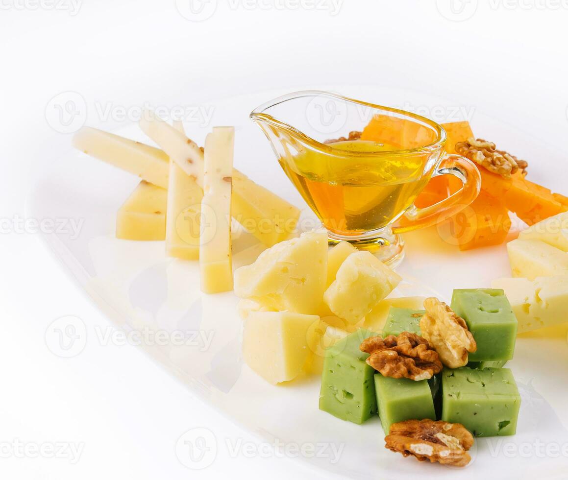 Cheese Platter with Honey, Nuts on white plate photo