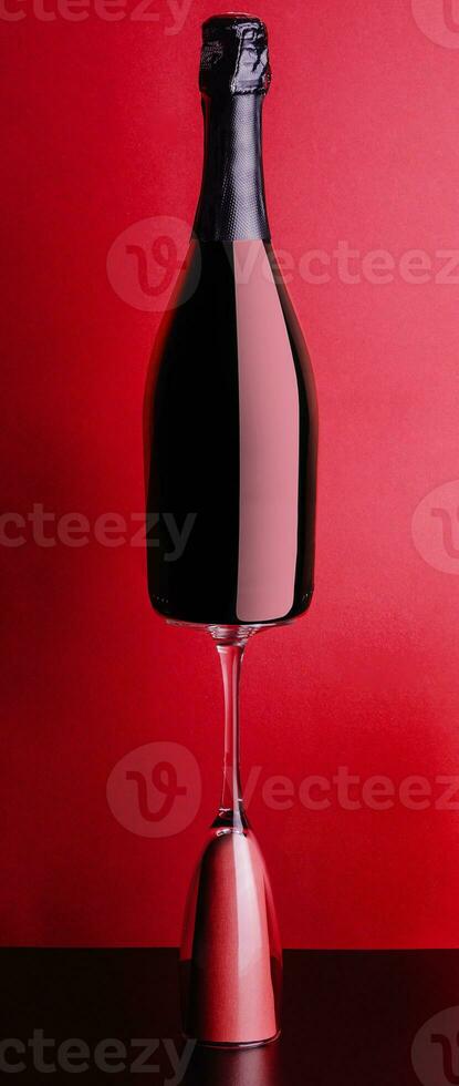 concept of bottle and glass of red champagne photo