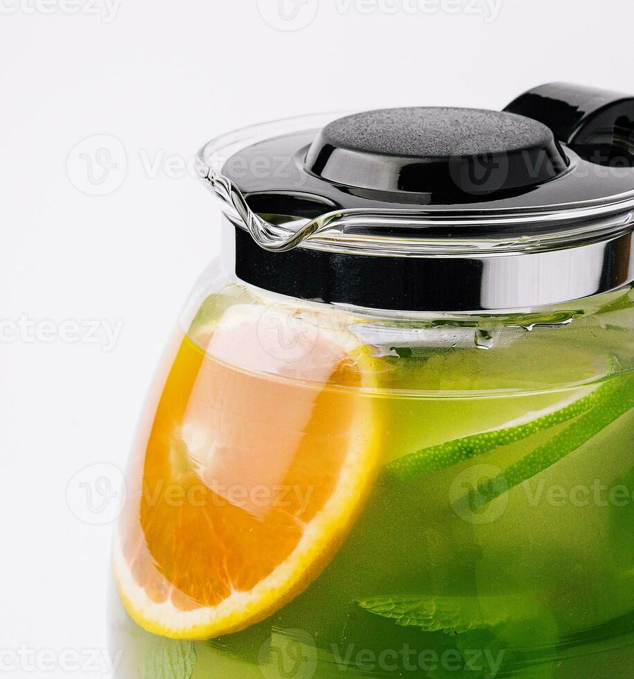 Jug of tasty cold tea on white background photo