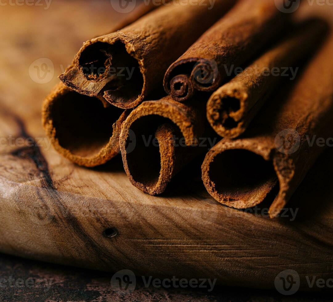 Cinnamon sticks on wooden background close-up photo