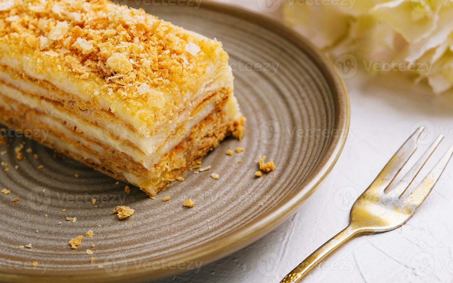 Napoleon cake on plate on table close-up photo