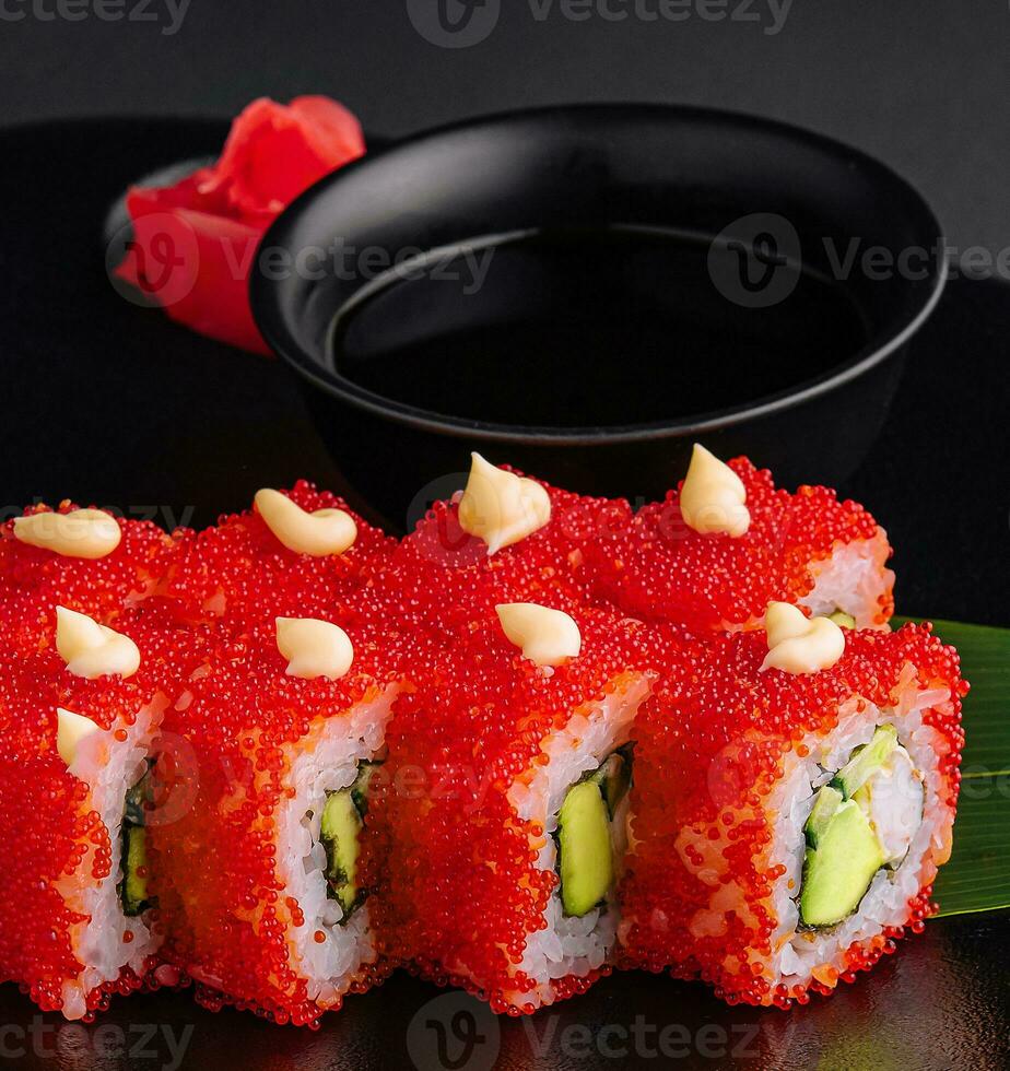 California Sushi roll cutting on black plate photo