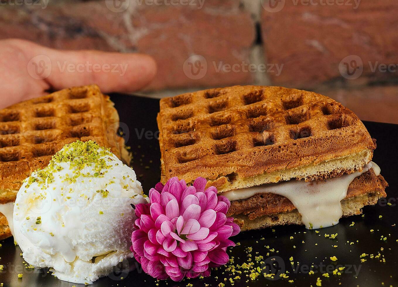 Belgian waffles with ice cream in black plate photo