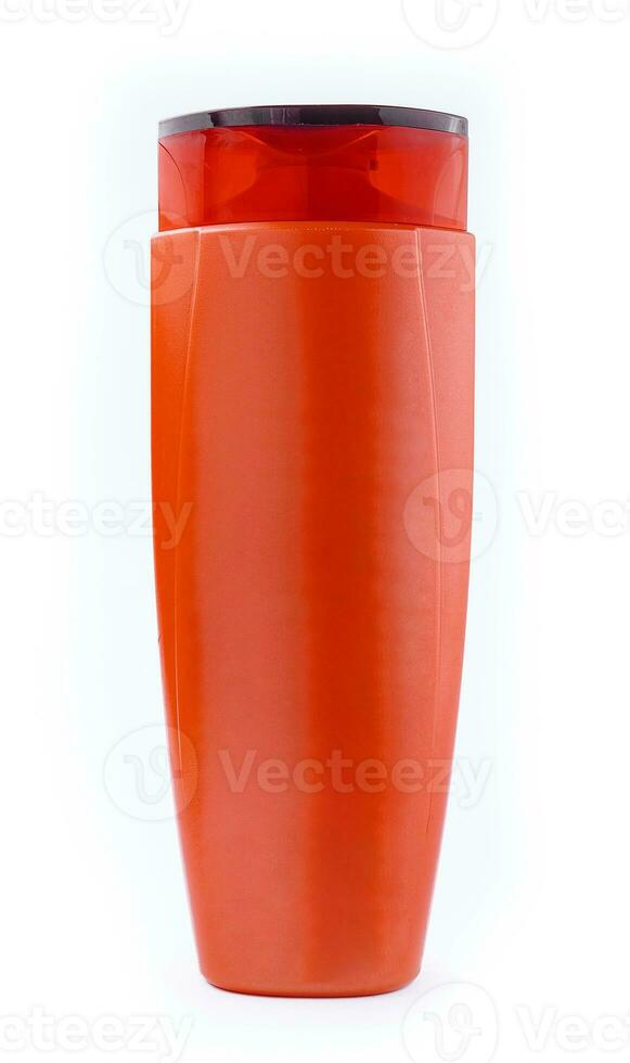 Red plastic bottle with shampoo gel on white background photo