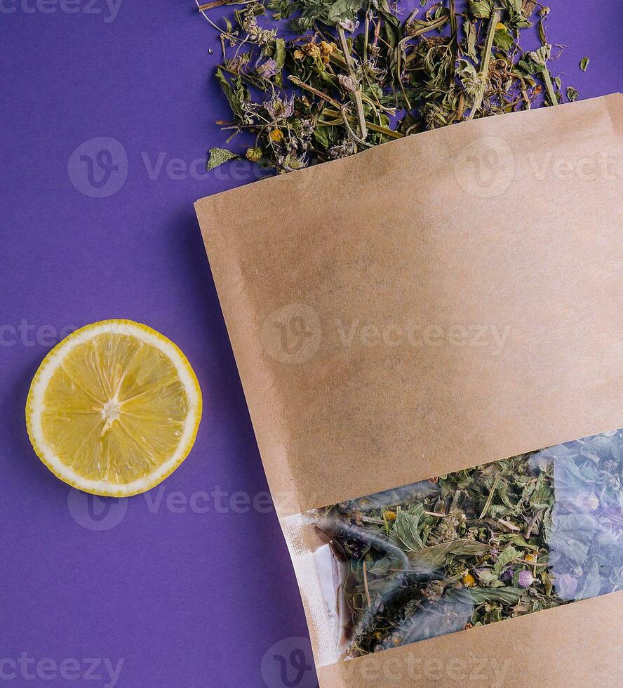 Dried and fresh tea leaves with lemon slices photo