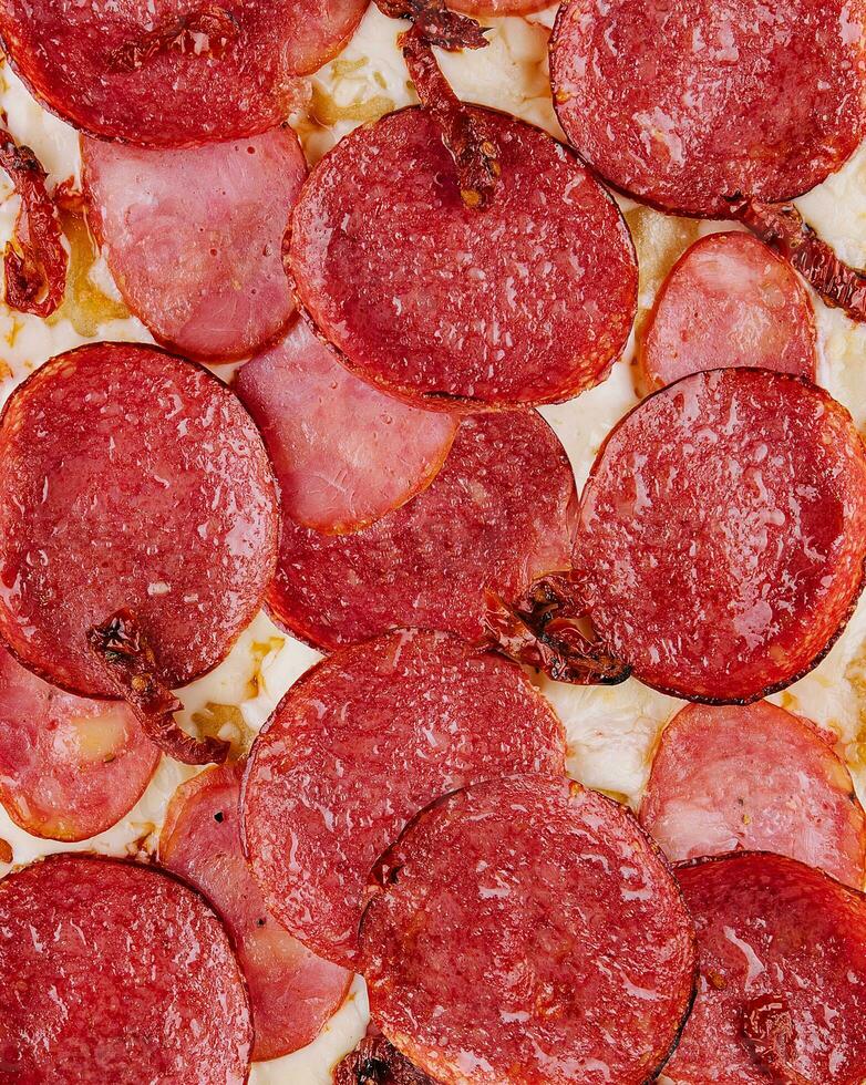 Pepperoni pizza close up background or texture photo