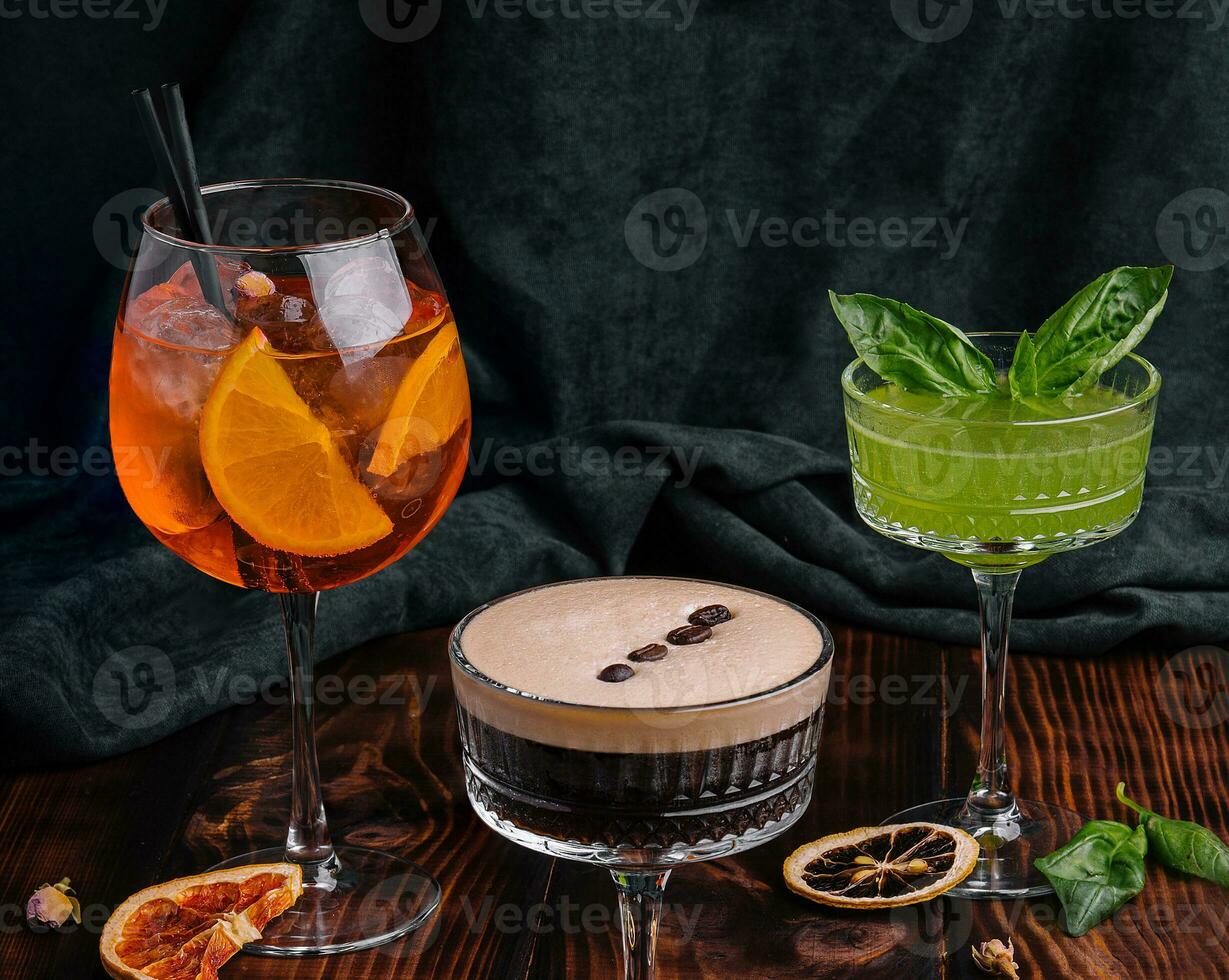 different colorful exotic alcoholic cocktails on wood photo