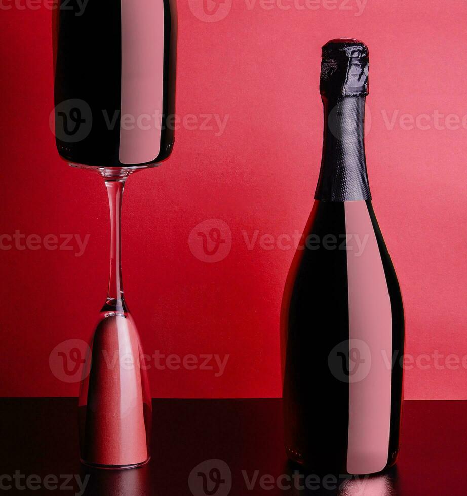 concept of two bottles and glass of red rose champagne photo