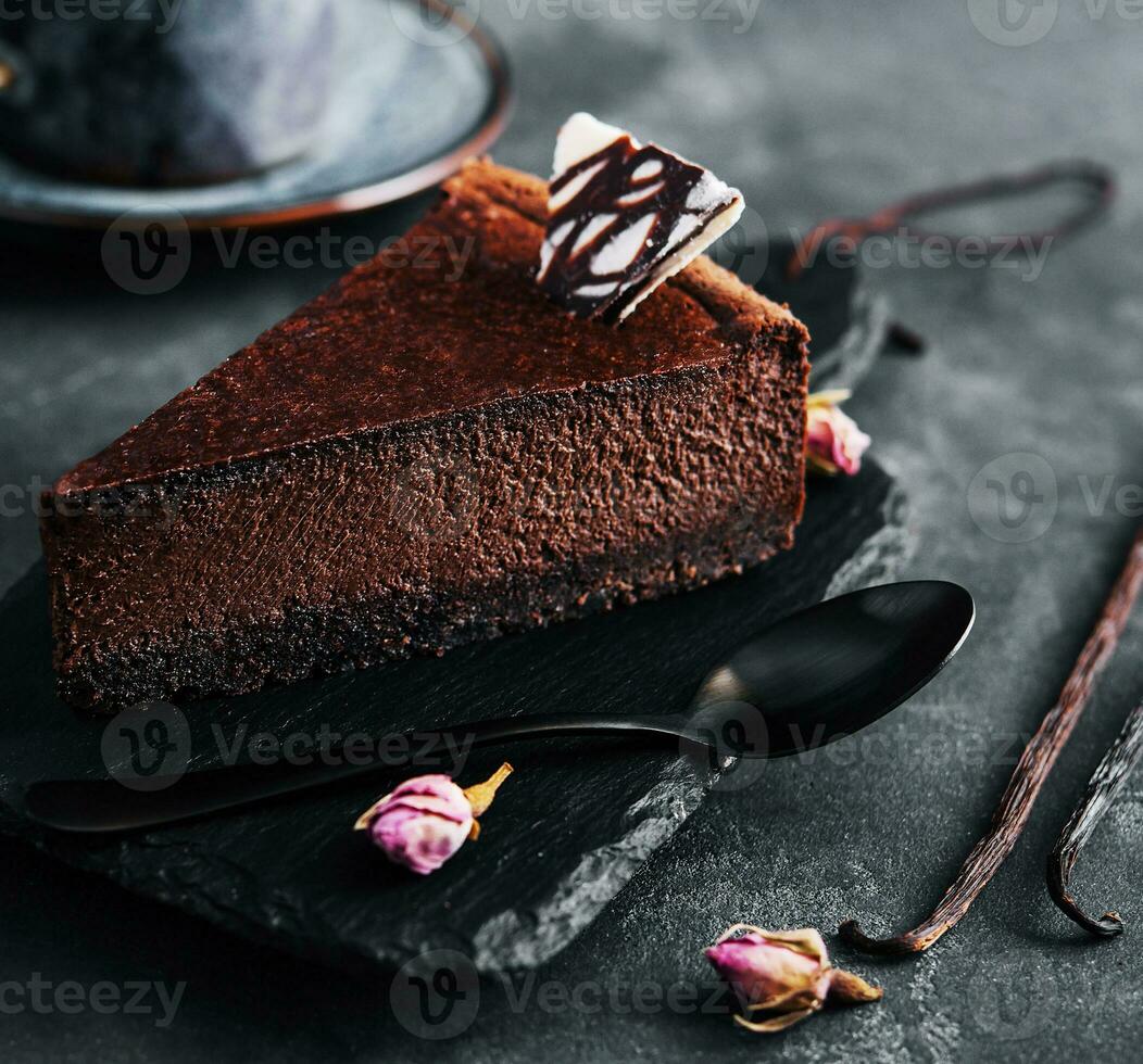 Chocolate cheesecake on black stone board photo