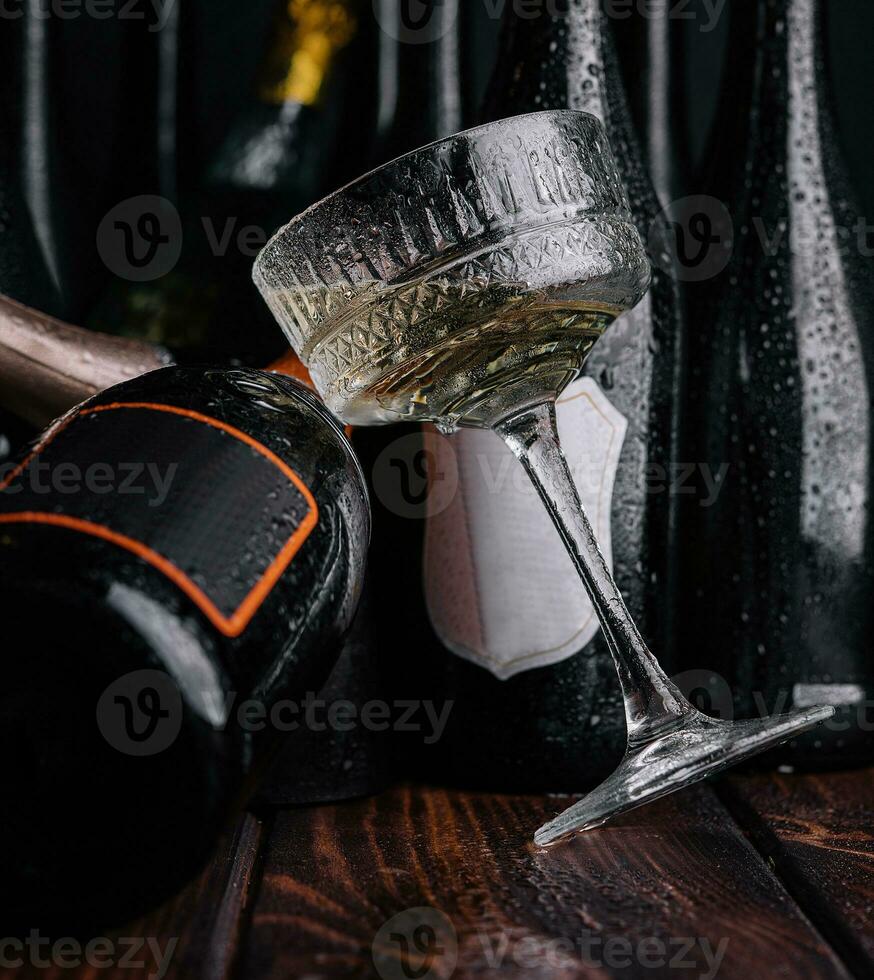 different bottles of champagne with a glass of white champagne photo