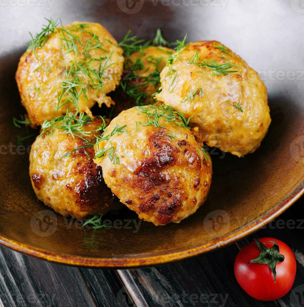 Fried meatballs decorated with salad and tomatoes photo