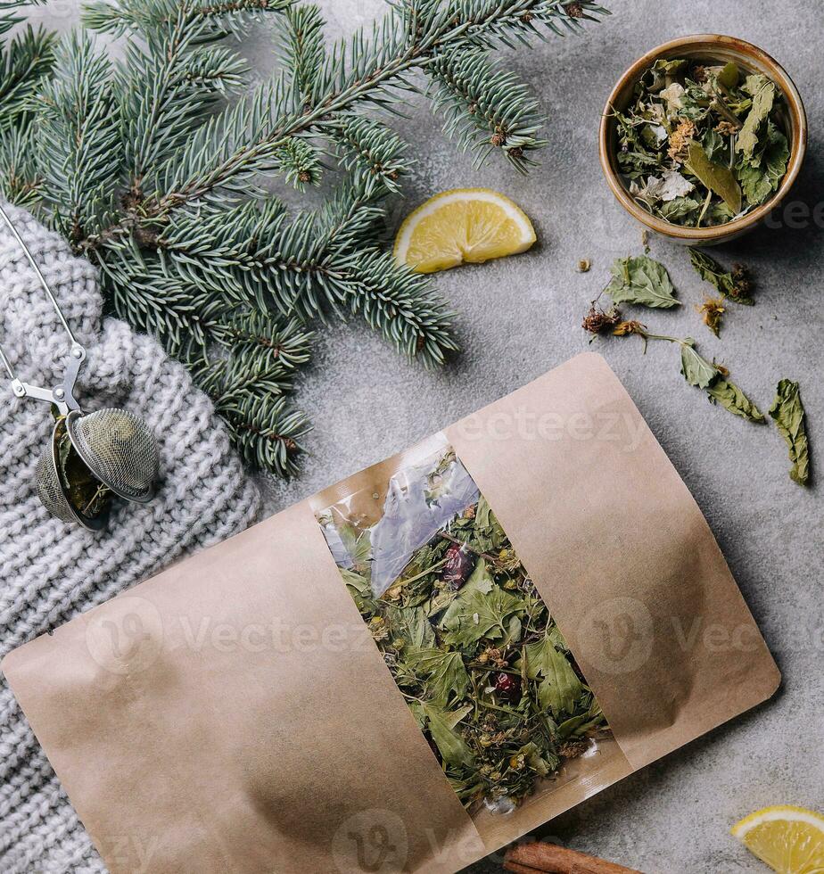 Hot tea in a cup with dried tea in a package photo