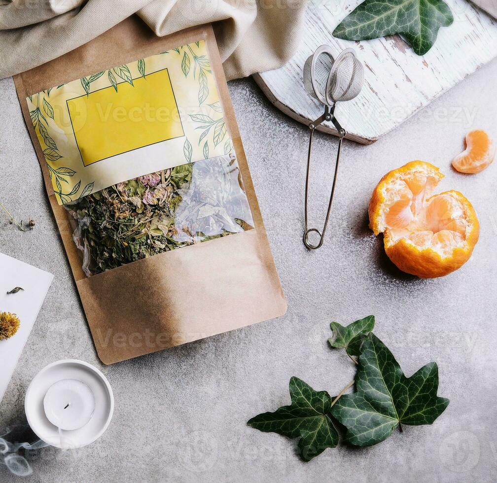 cup of tea with tangerines and tea packaging photo