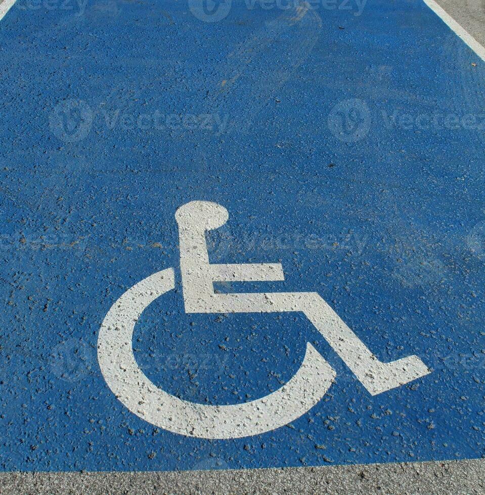 Disabled parking sign on the street. Wheelchair logo. photo