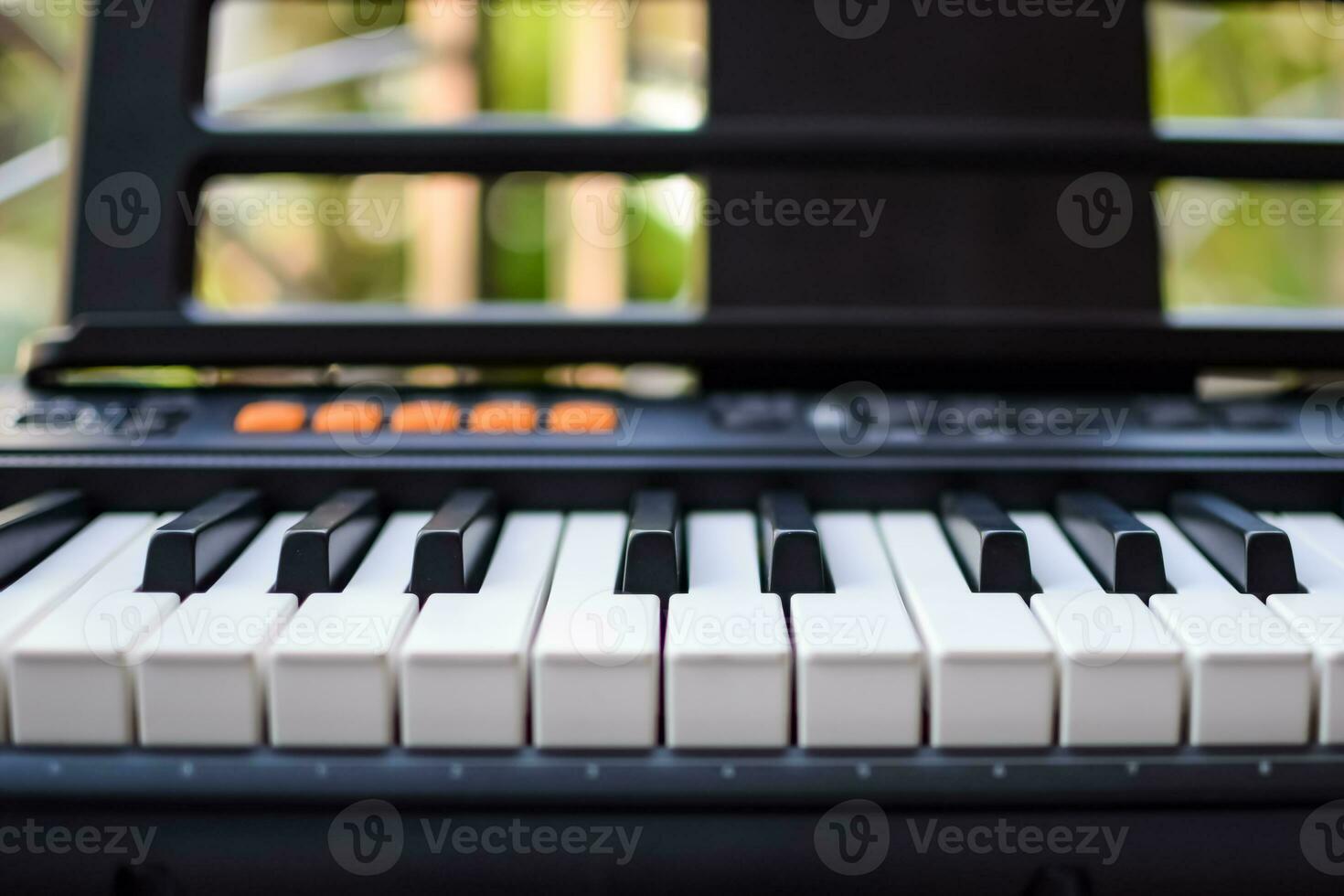 Close-up of piano keys. Piano black and white keys and Piano keyboard musical instrument placed at the home balcony during sunny day. photo