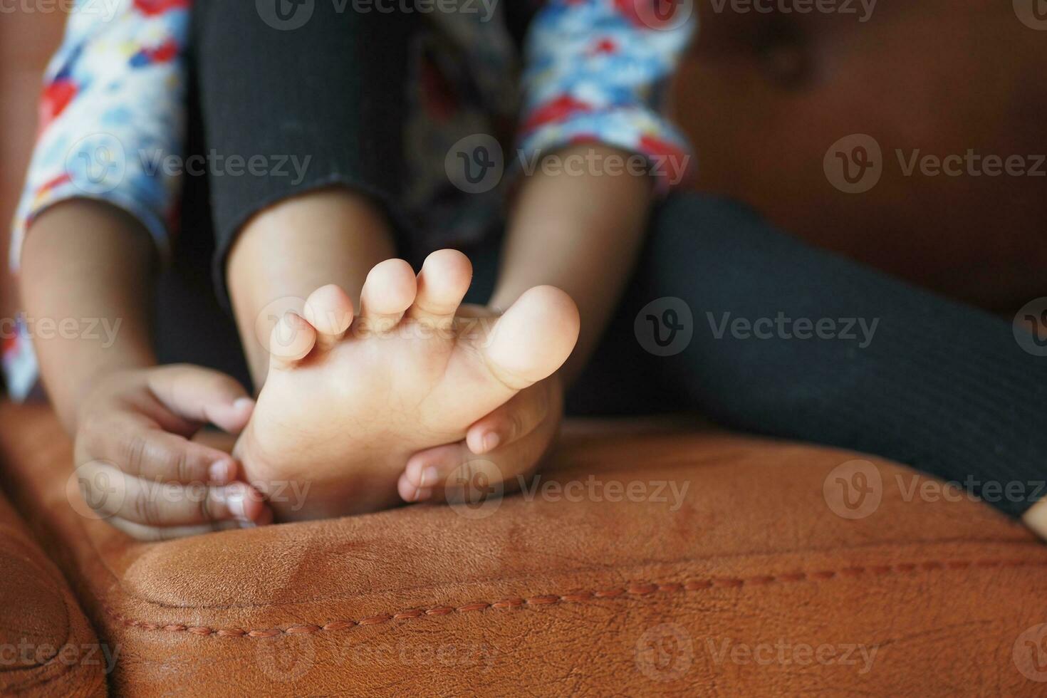6 year old child suffering pain on feet photo