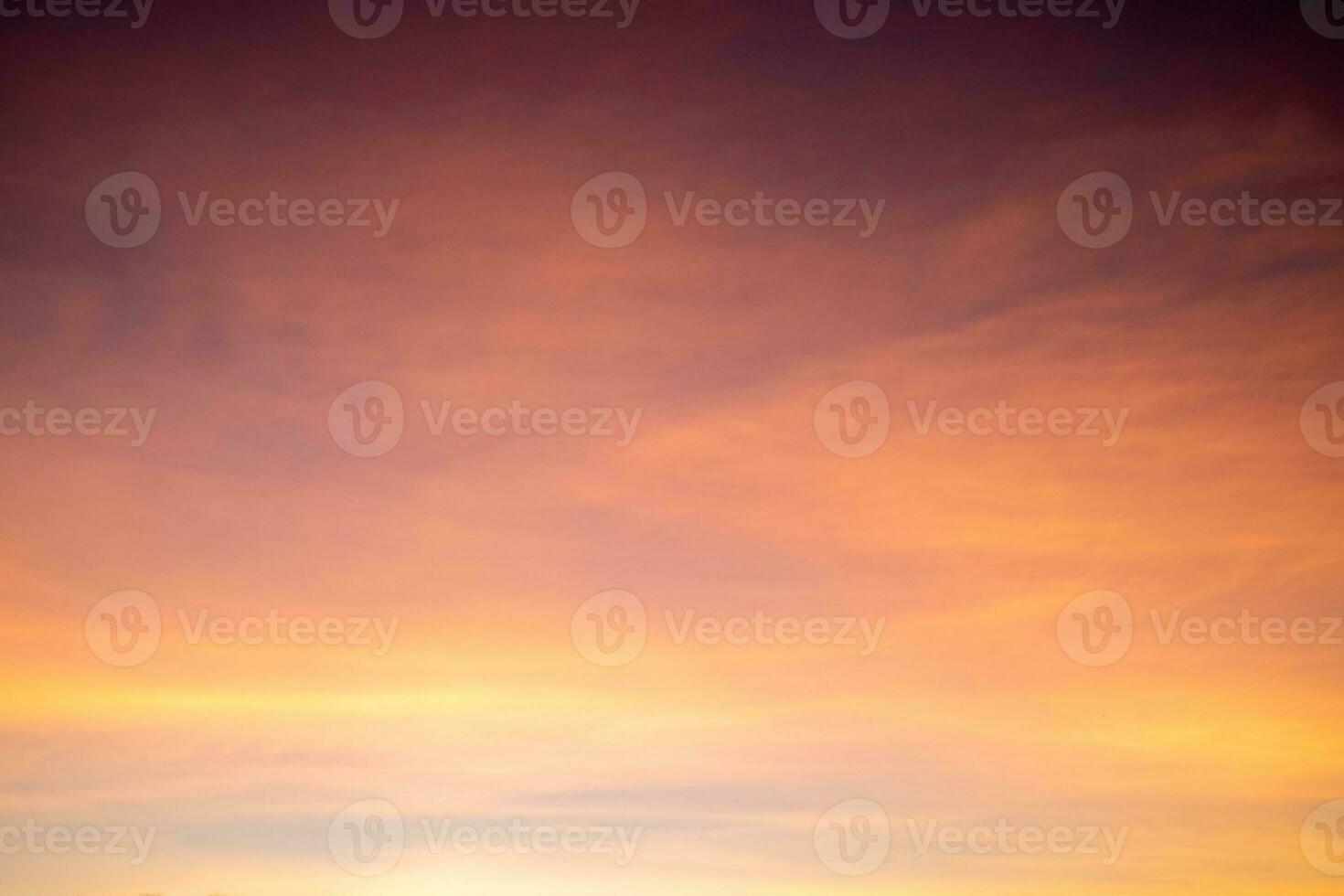 Beautiful of luxury soft gradient orange gold clouds and sunlight on the blue sky perfect for the background, take in everning,Twilight photo