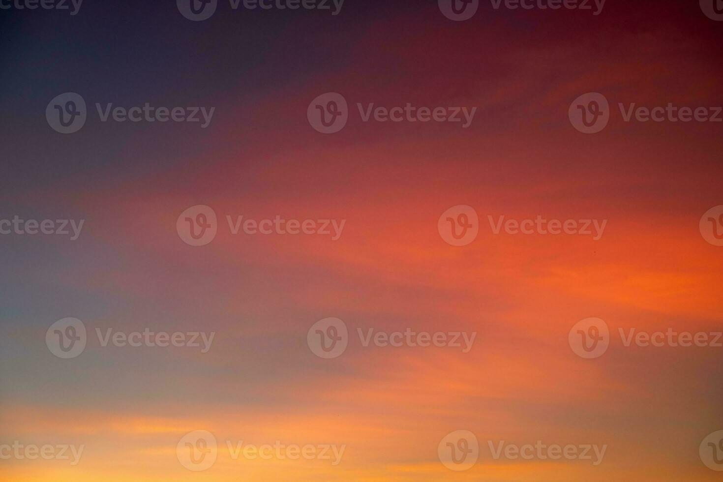 Beautiful of luxury soft gradient orange gold clouds and sunlight on the blue sky perfect for the background, take in everning,Twilight photo