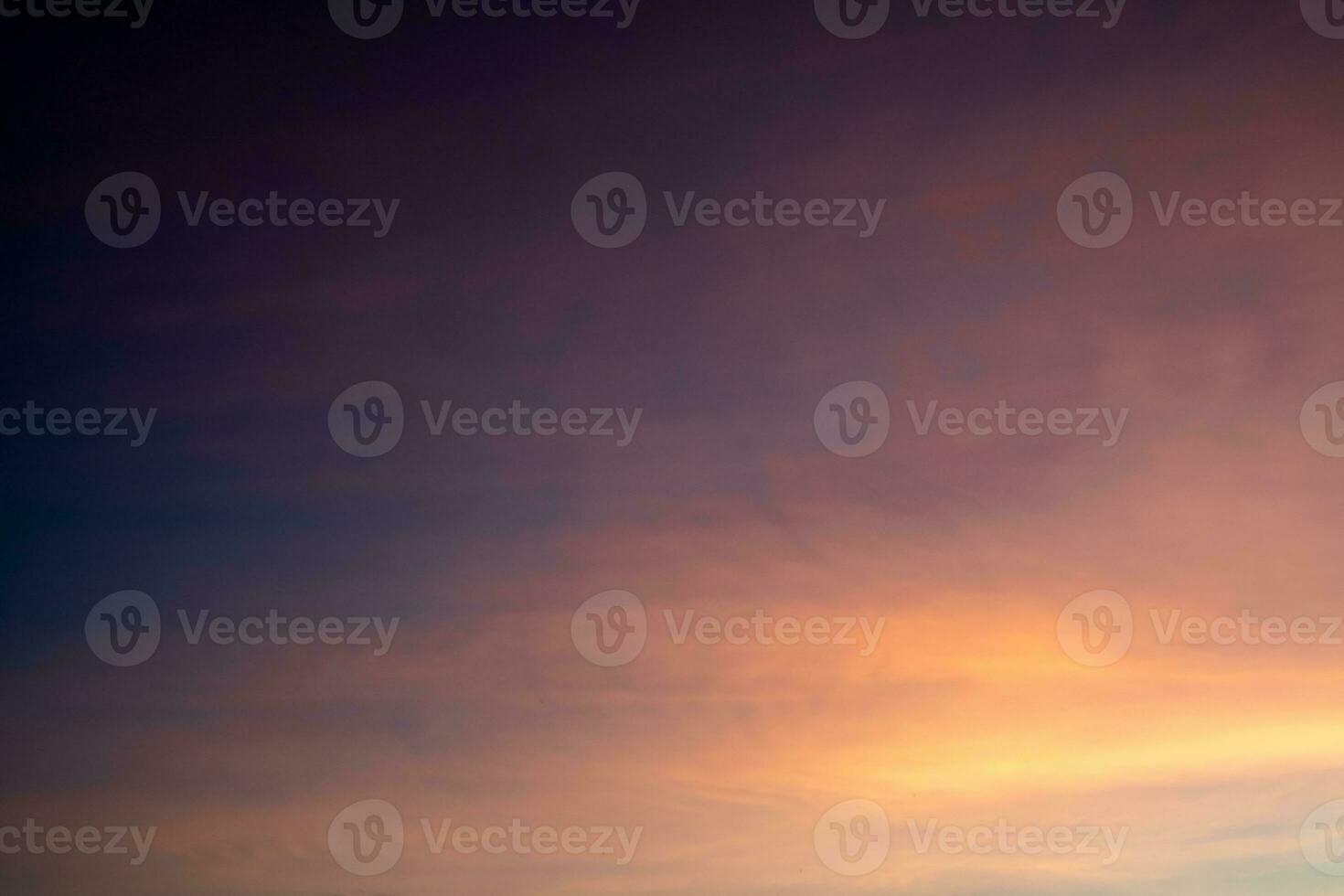 Beautiful of luxury soft gradient orange gold clouds and sunlight on the blue sky perfect for the background, take in everning,Twilight photo