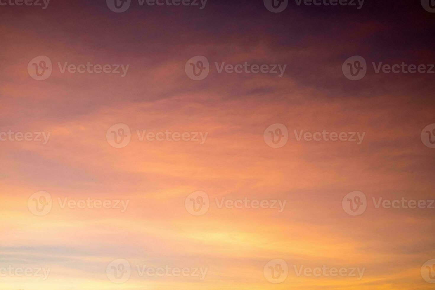 Beautiful of luxury soft gradient orange gold clouds and sunlight on the blue sky perfect for the background, take in everning,Twilight photo