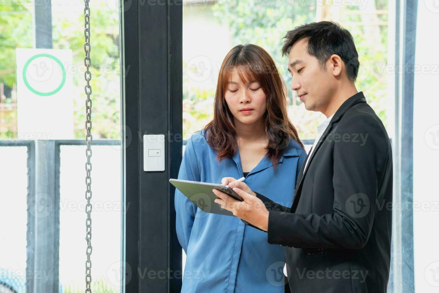 They are working, thinking, and planning on the tablet of a business team developing a project. The technology marketing group works with web research. Office workers are looking at tablets together. photo