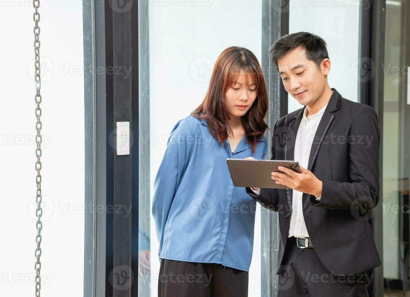 They are working, thinking, and planning on the tablet of a business team developing a project. The technology marketing group works with web research. Office workers are looking at tablets together. photo