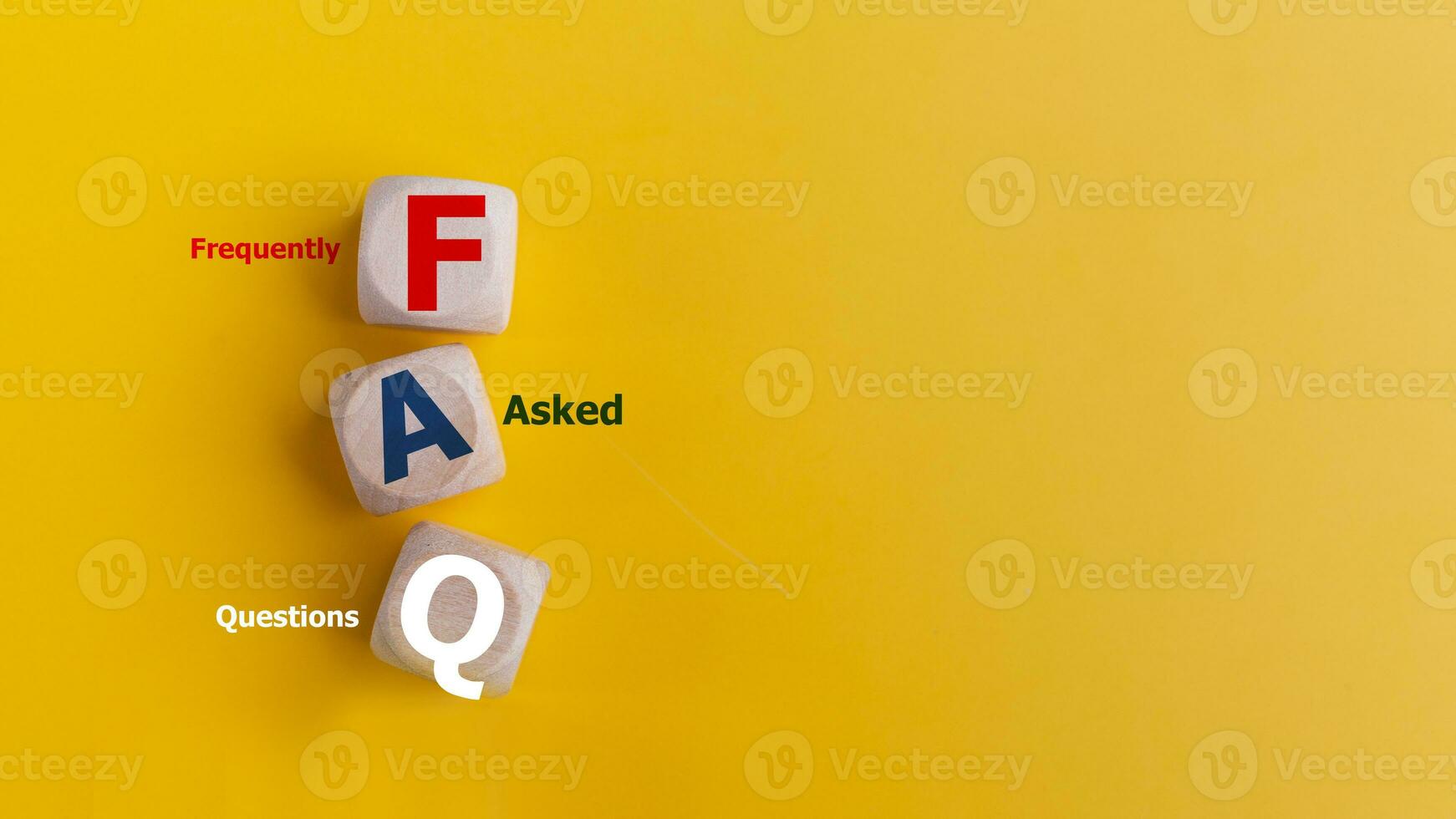 FAQ concept on wooden cubes and word FAQ on a yellow background. photo
