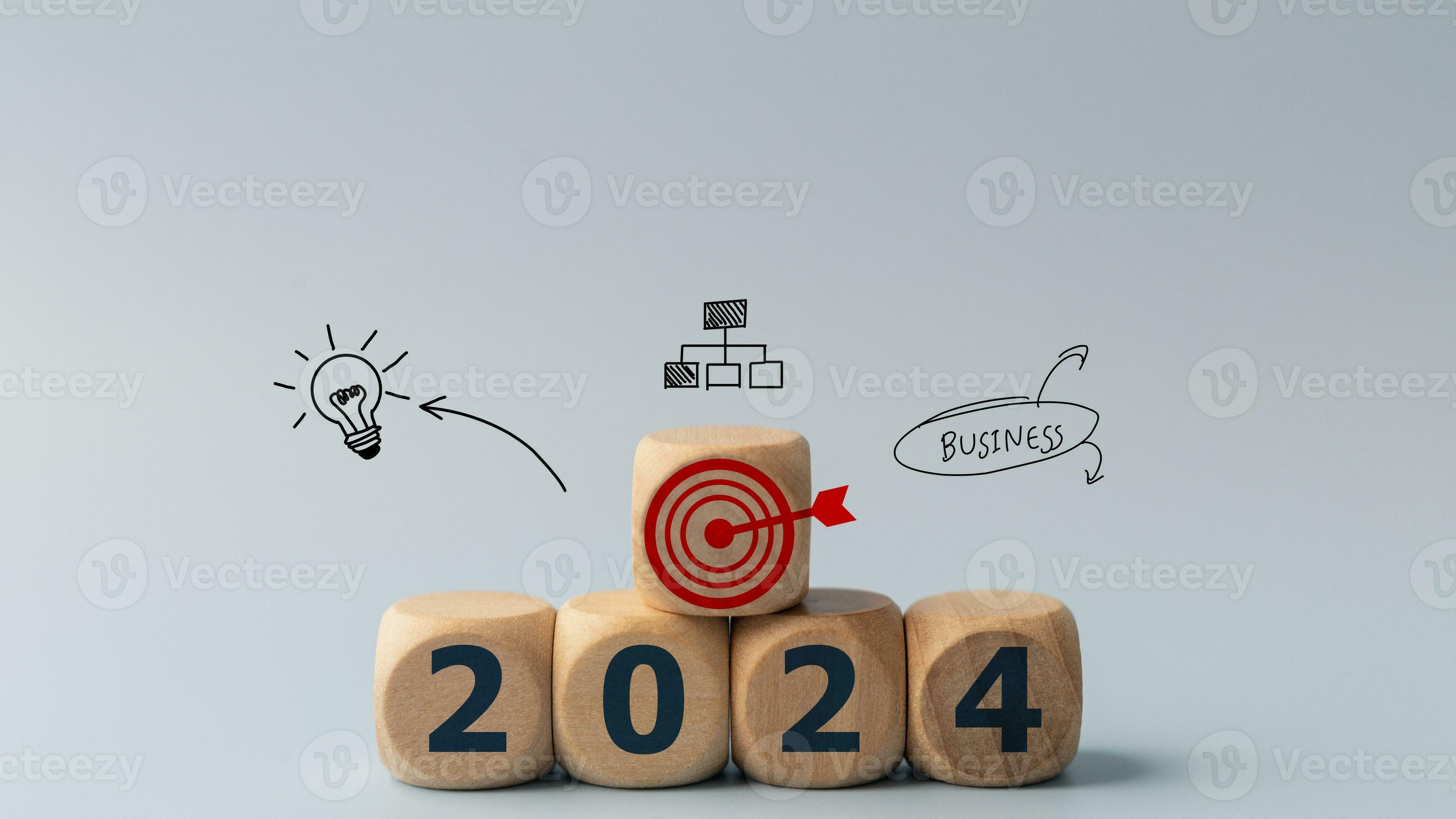 2024 goals of business or life. Wooden cubes with 2024 and goal icon on