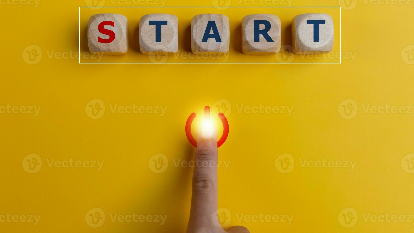 The word start on wooden cubes with a hand pressing the start button. To make a new start in life, business, education, or career concept. photo