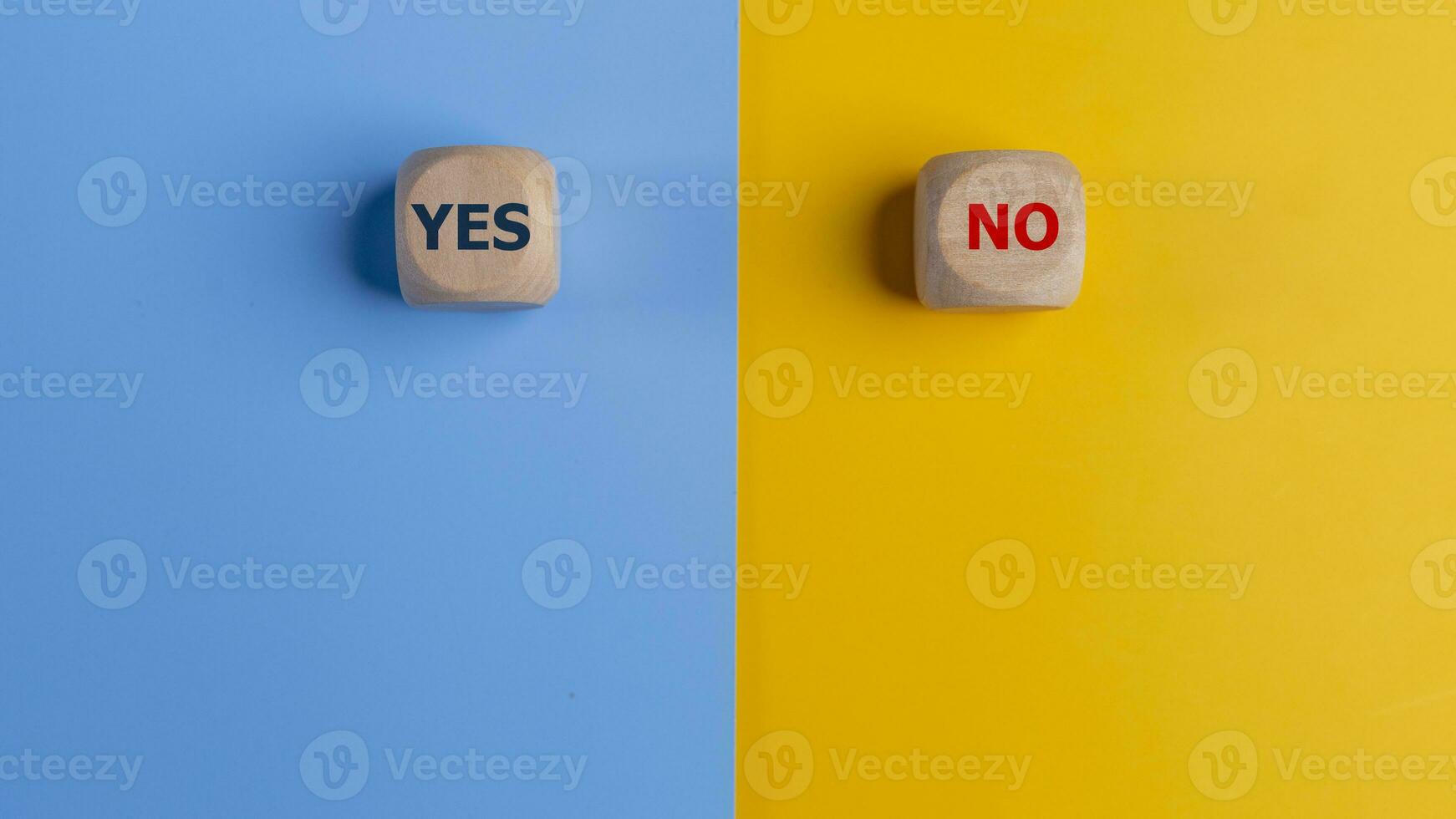 Wooden cube with yes and no text on a blue and yellow background. Business Choices For Difficult Situations, making Decisions. photo